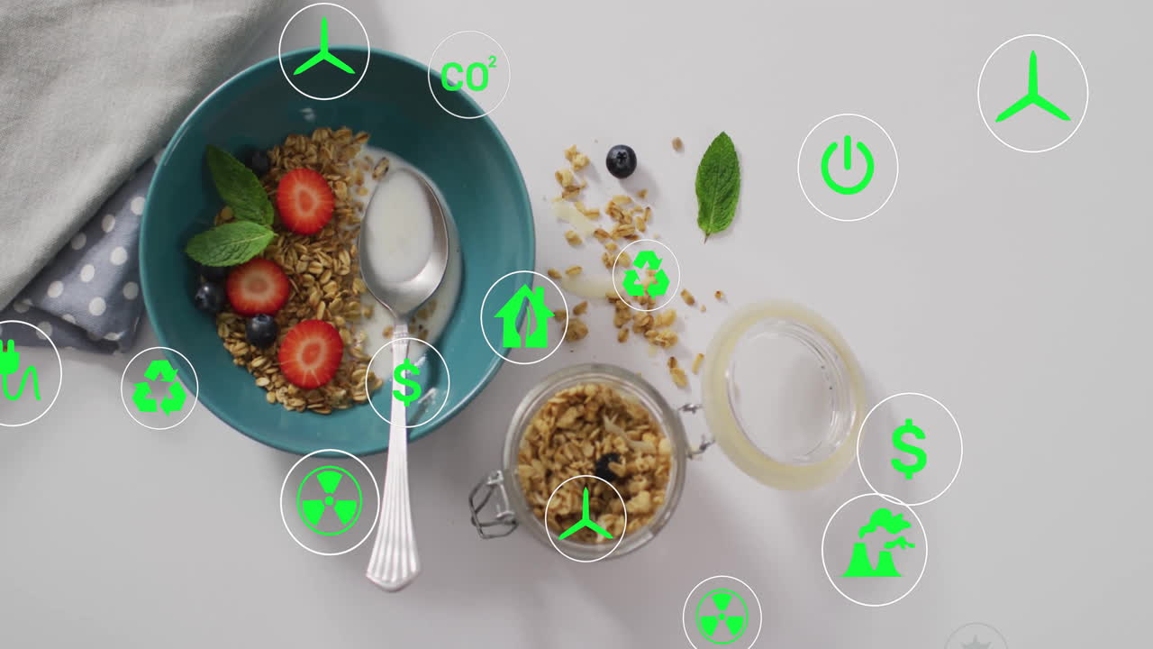 Green eco-friendly icons overlay on granola and strawberries on table