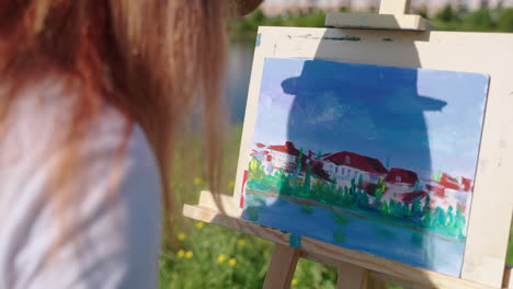 woman painting a landscape outdoors