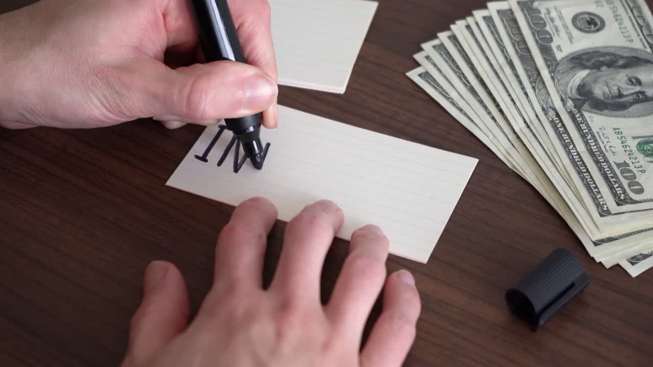 Writing the word &amp;quot;Investment&amp;quot; on a piece of paper