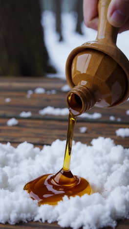 maple syrup pouring onto snow
