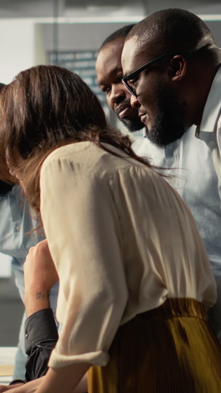 Vertical Video Employees reviewing charts and diagrams during a project briefing
