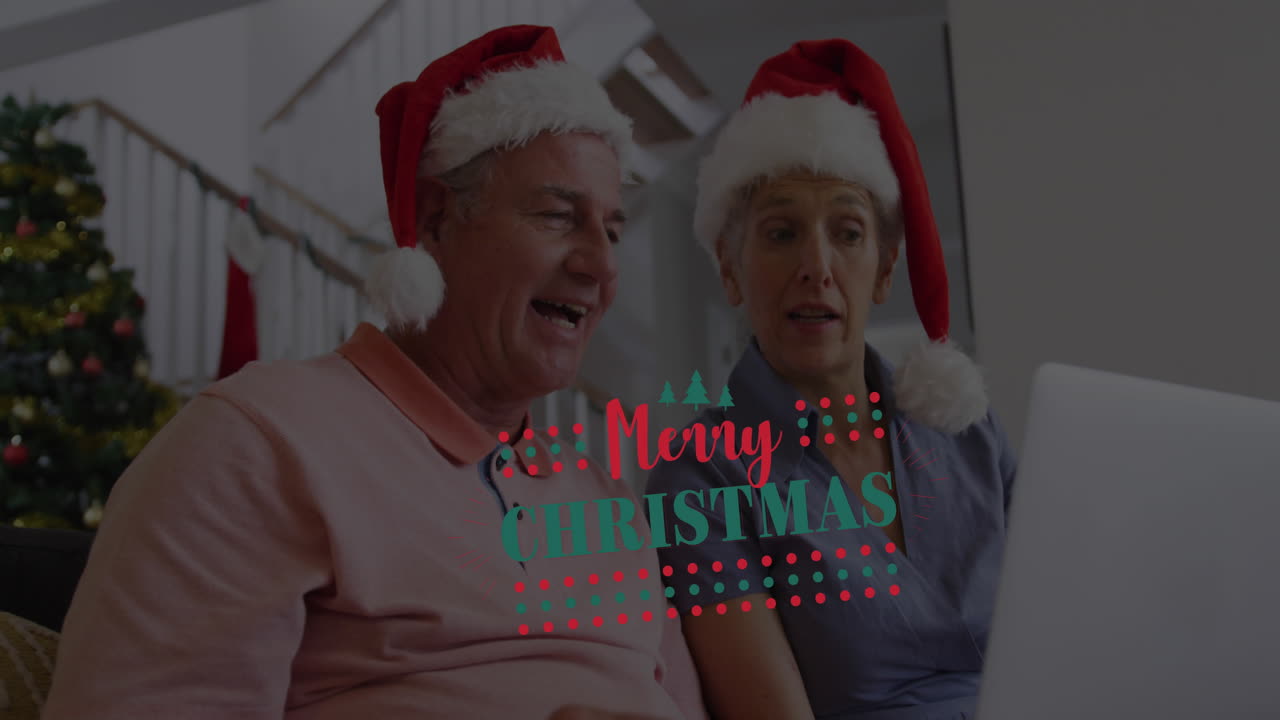 Animação de texto 'Feliz Natal' sobre casal caucasiano idoso usando gorros de Papai Noel e usando laptop