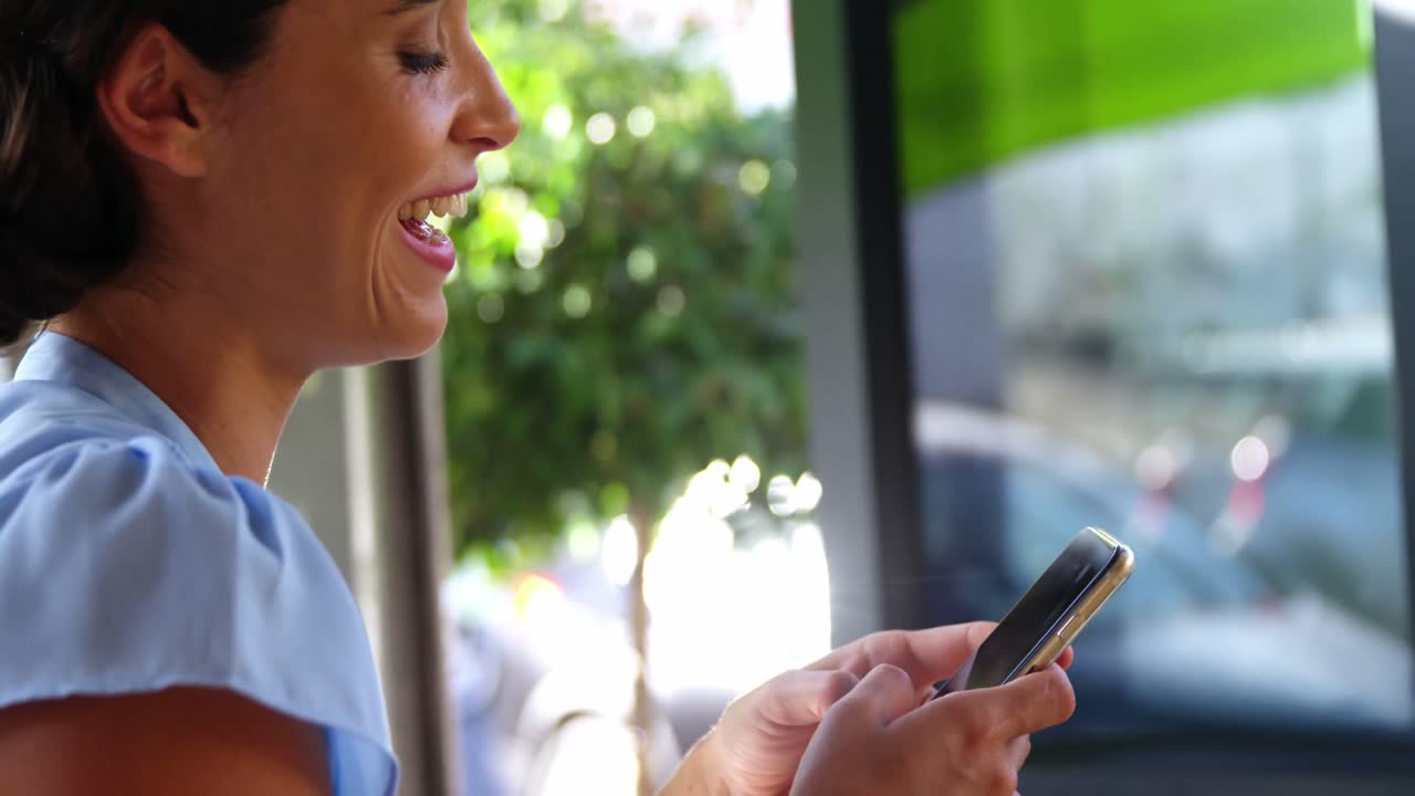 Smiling businesswoman using mobile phone