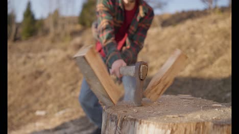 man chopping wood with an axe
