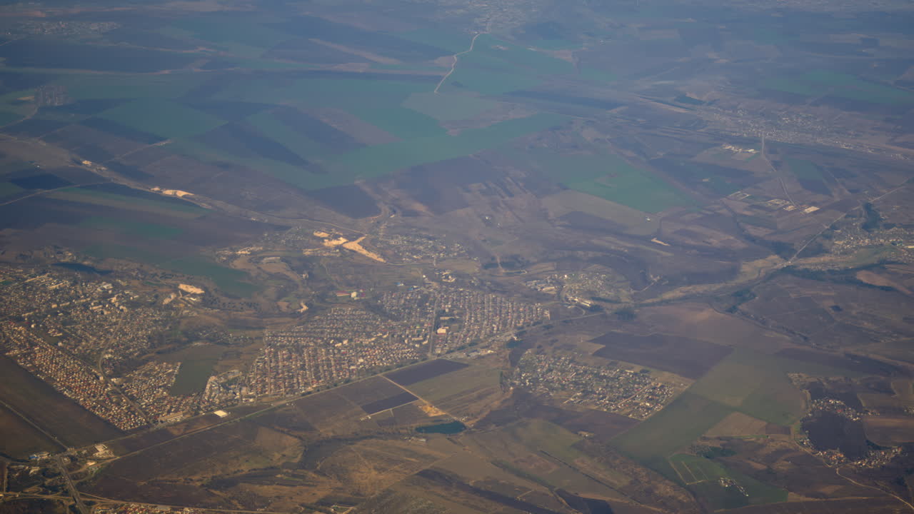 Aerial view of fields and towns from an airplane window