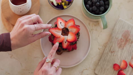 Hands,-strawberry-dessert-and-cooking-in-kitchen