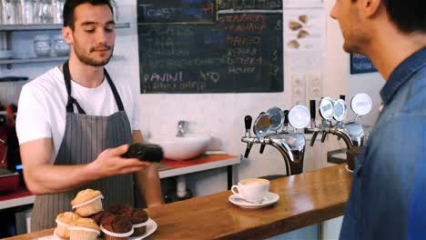 Customer-making-payment-through-credit-card-at-counter