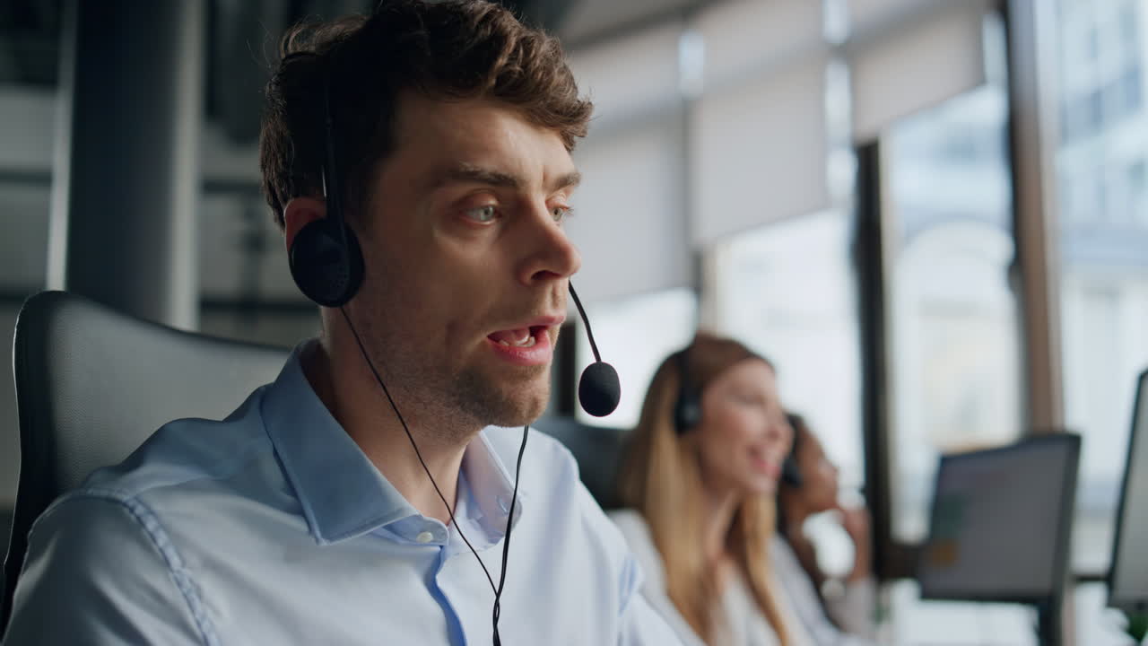 Closeup technical assistant talking in call center. Focused man listening client