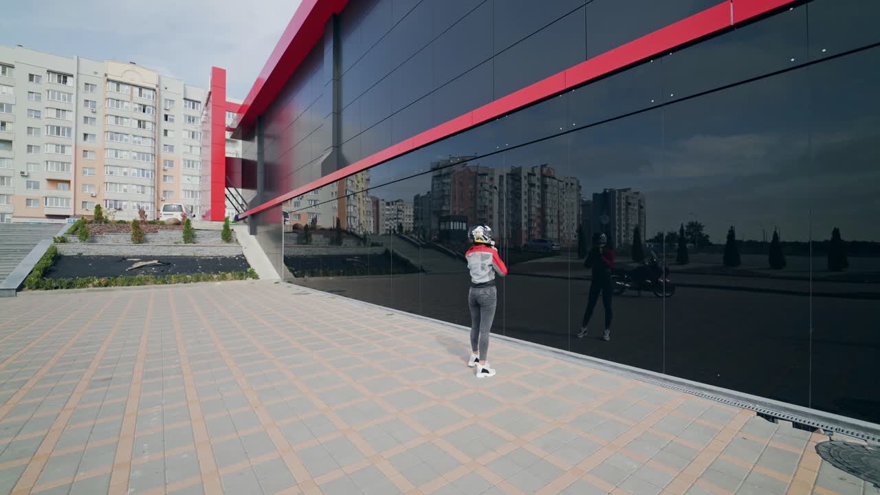 Woman wearing moto helmet. Girl biker with perfect fit slim tamed body and long hairs