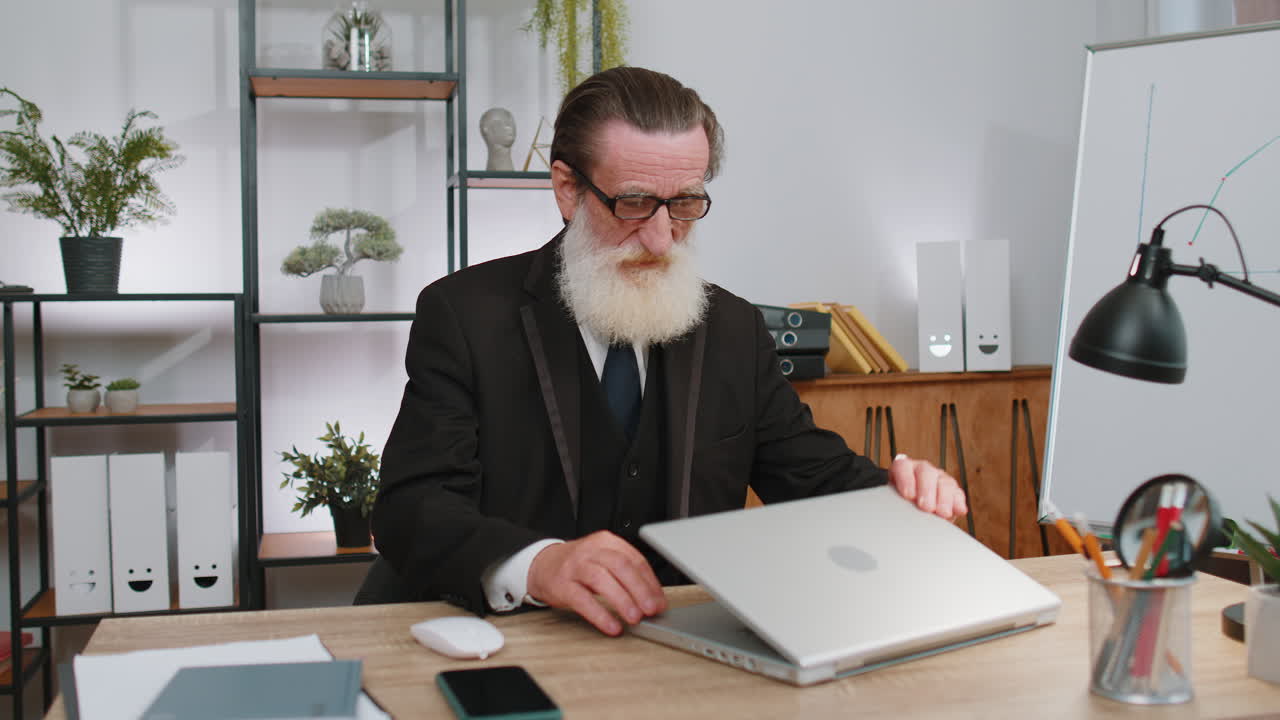 Senior business man freelancer at office, start working on laptop computer, sends online messages