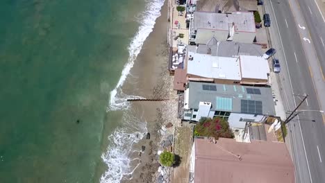 along the malibu coastline live the richest people in beach houses in california
great aerial view flight bird's eye view slowly tilt up drone footage at topanga usa 2018