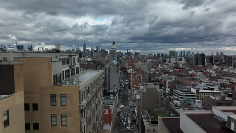 Forwards-fly-between-tall-buildings.-Revealing-downtown-panorama-against-dramatic-sky.-Modern-tall-buildings.-Manhattan,-New-York-City,-USA