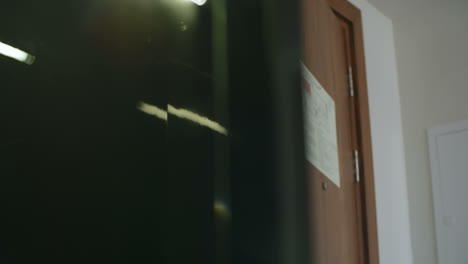 young businessman in stylish clothes walking into hotel room