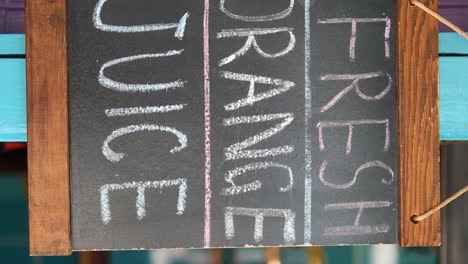 chalkboard sign advertising fresh orange juice