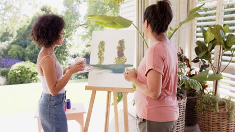 painting together, women enjoying outdoor art session with canvas and brushes