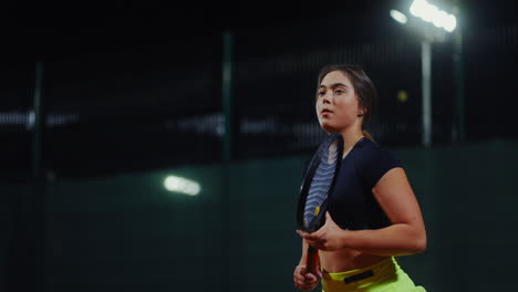mujer jugando al tenis por la noche