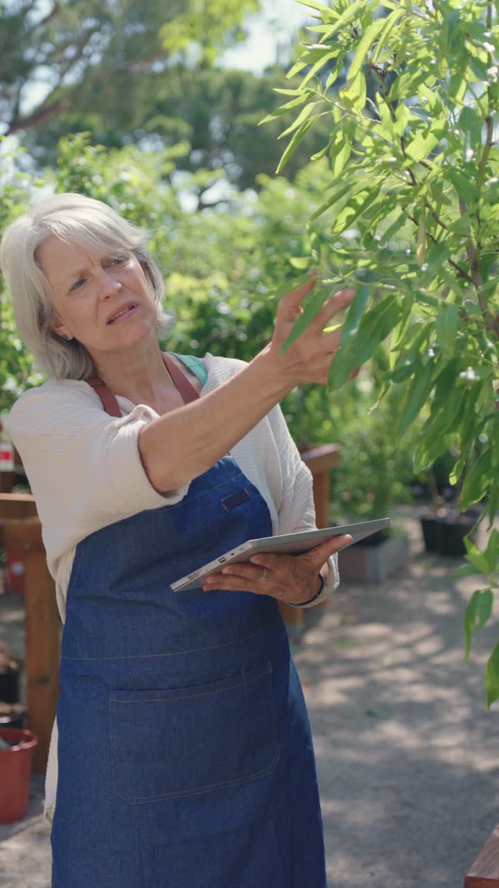 Woman using tablet in garden center
