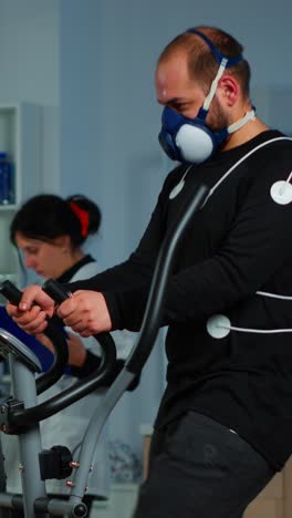 man undergoing cardiopulmonary exercise test on elliptical machine in a lab