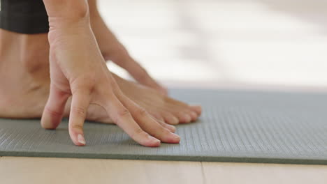 close up hands yoga woman practicing poses enjoying fitness lifestyle exercising in studio stretching body training on exercise mat