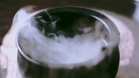 witch's cauldron bubbling with green potion in a spooky halloween scene