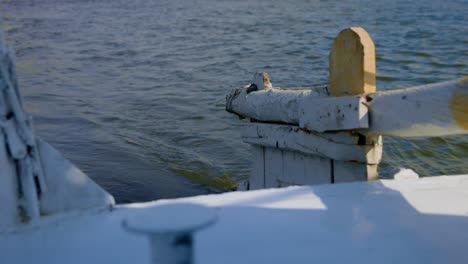 unmanned white crude wooden rudder of ship sailing slowly on sea