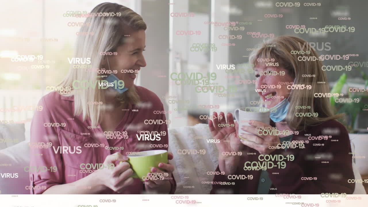 Animation of covid 19 text over happy caucasian senior women wearing face masks drinking coffee