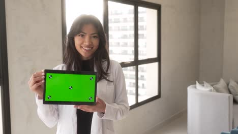 beautiful-asian-woman-holding-tablet-smiling-horizontal-light-slow