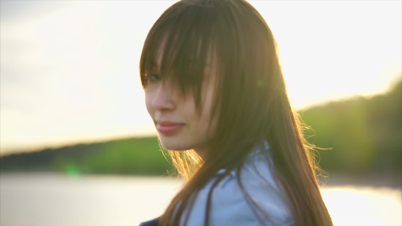 Woman at Sunset by the River