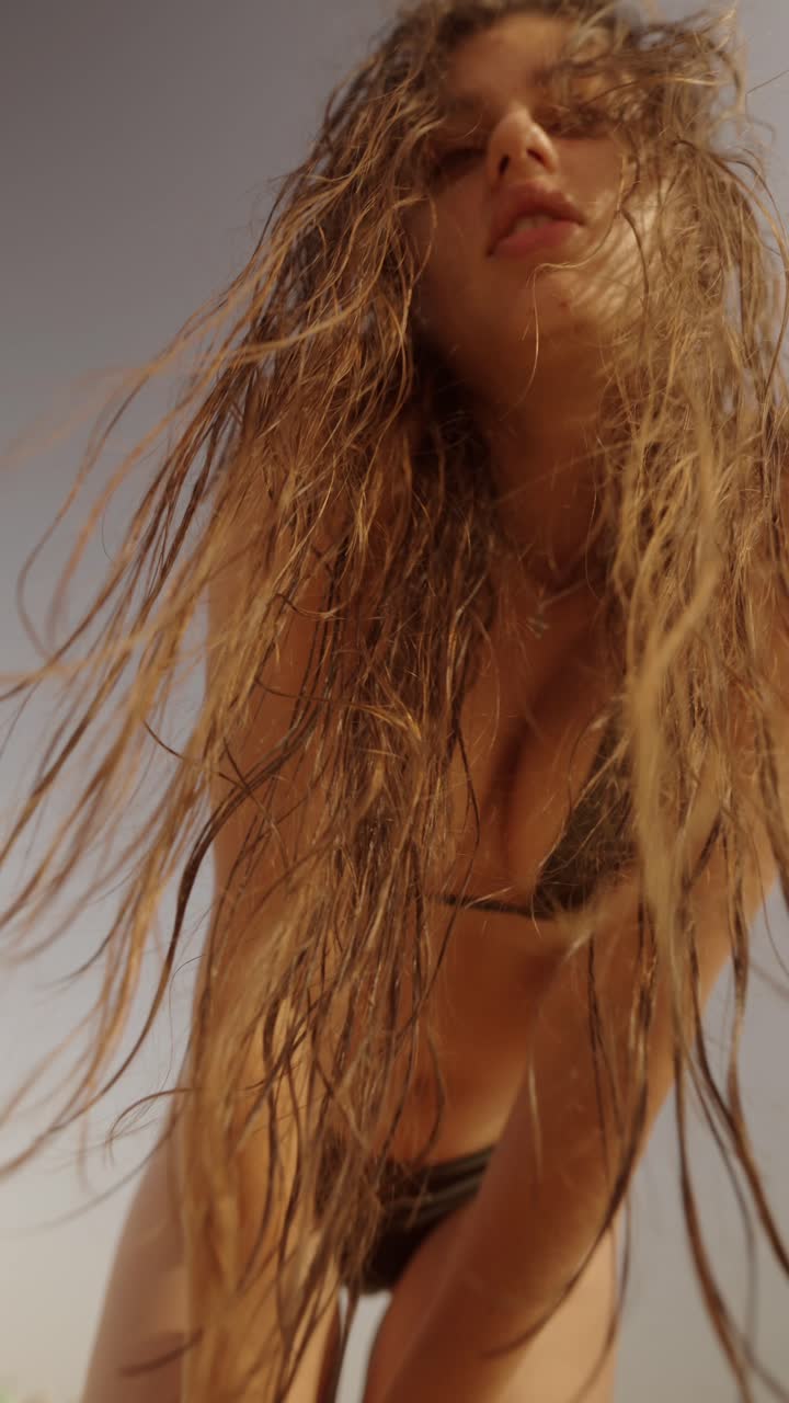 Woman with wet hair on the beach