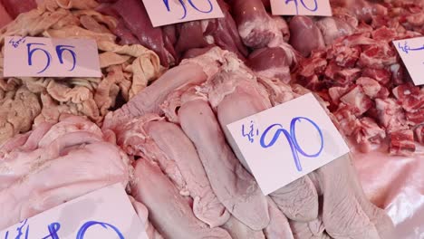 assorted meats priced and displayed at a butcher