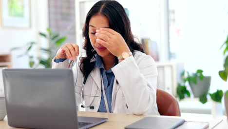 Doctor,-woman-and-headache-with-laptop-in-hospital
