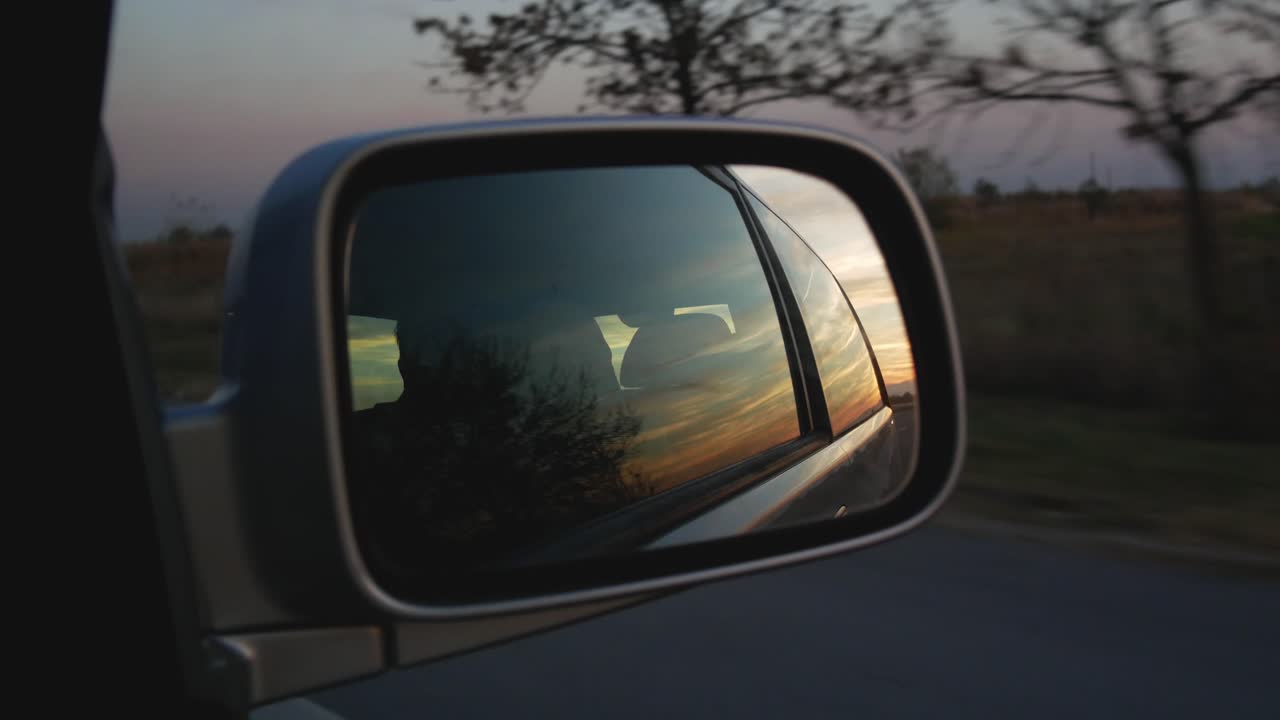 Sunset View In Right Side Mirror In Car Driving On The Road