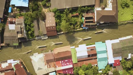 birdseye aerial view of amphawa floating market and boats sailing in water canal. thailand countryside