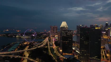 twilight night illumination singapore city famous downtown bay flyer traffic coastline road aerial panorama 4k