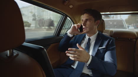 Focused-business-man-talking-on-phone-in-interior-of-automobile.-Man-in-car