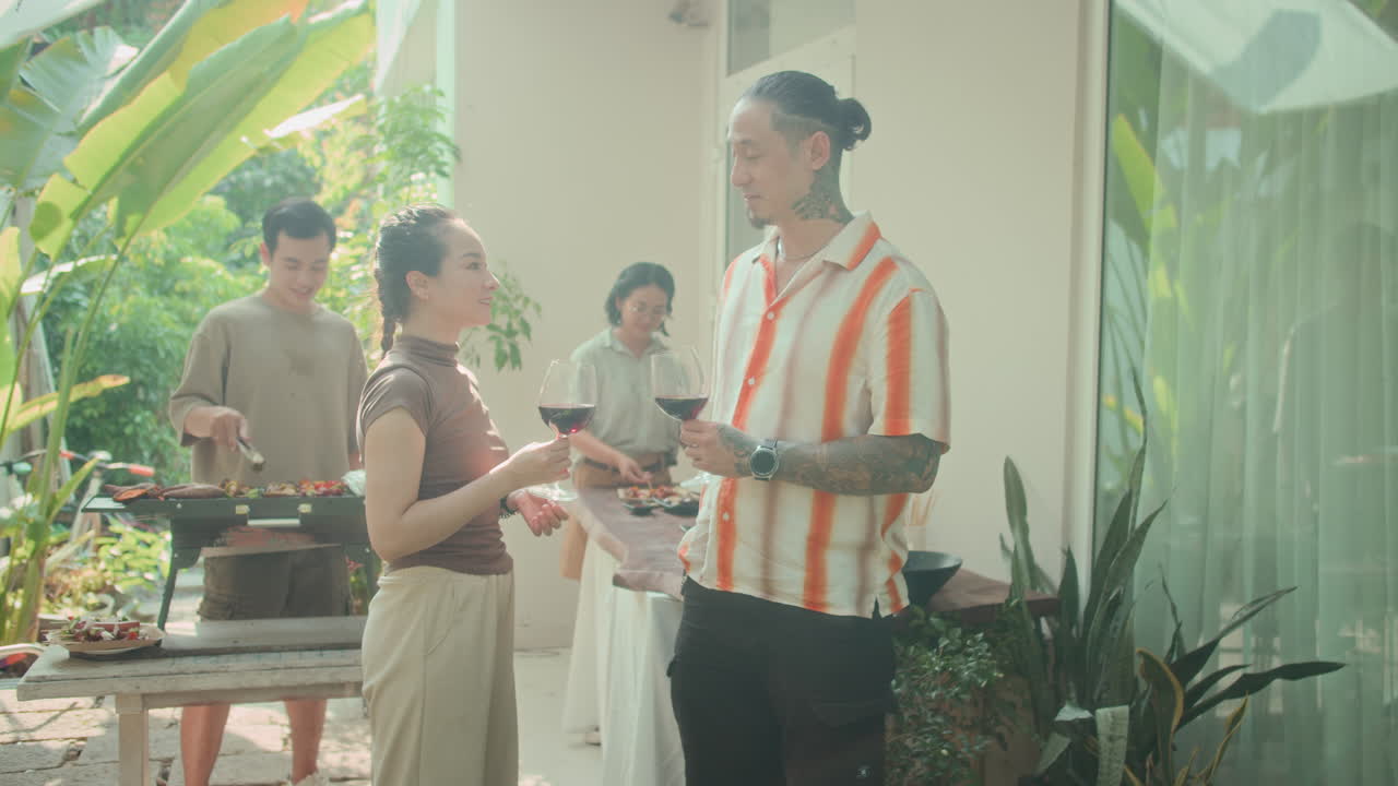 Group of People Toasting with Wine Having Grill Party