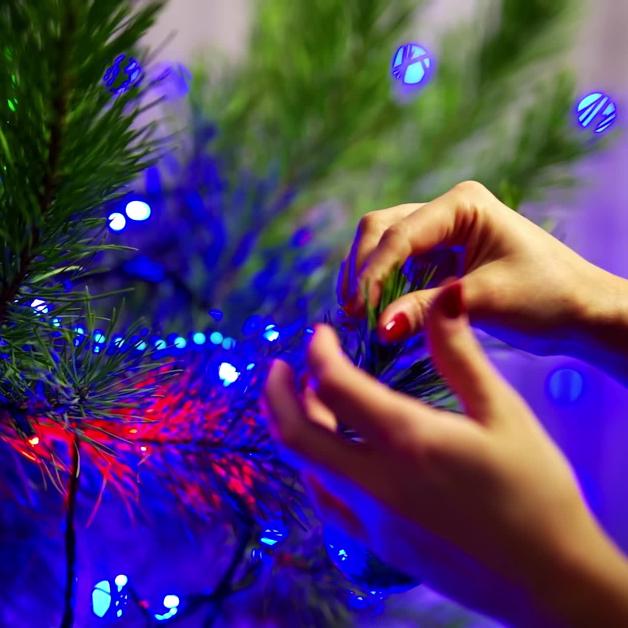 Girl decorates Christmas tree