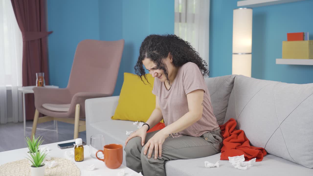 Young woman experiencing pain in bones.
