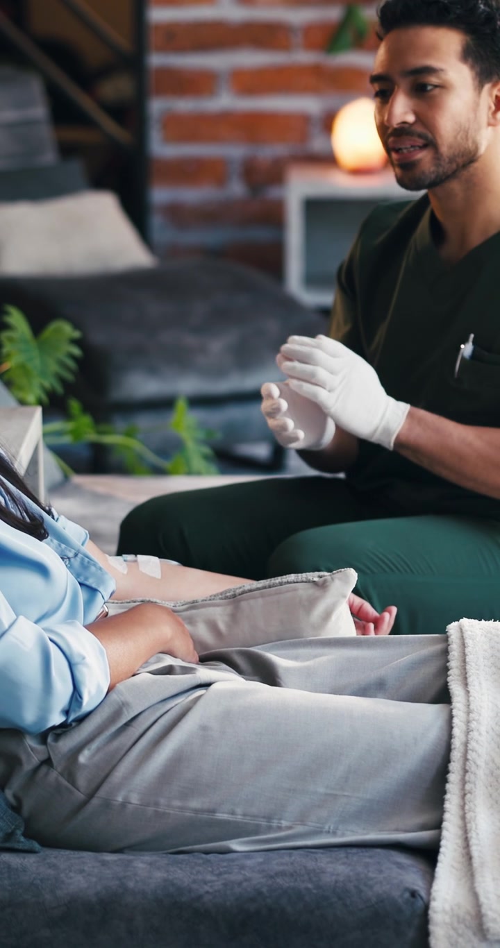 Male Nurse Providing Home Care to Female Patient