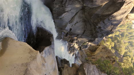 fast river flowing through rocky canyon, vertical video