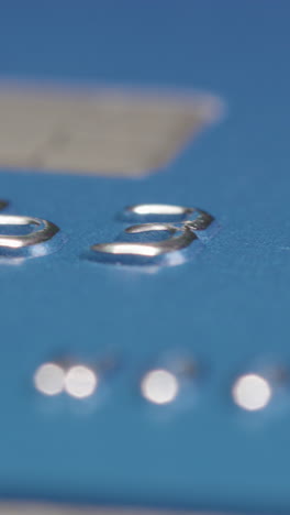 slider macro shot of a credit cards numbers, vertical