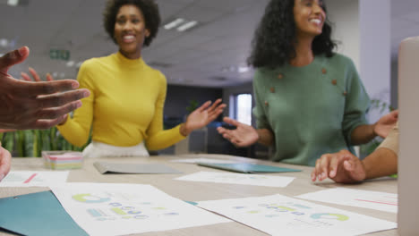 Happy-diverse-male-and-female-business-colleagues-teaming-up-in-office