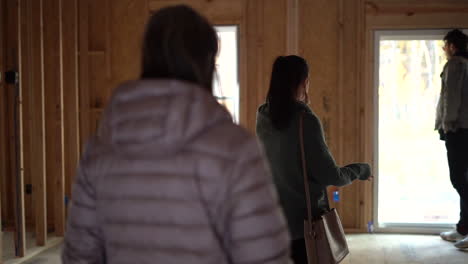 young woman is building a new home and shows friends and family where everything will go
