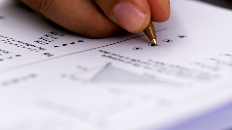 Examination, evaluations, tests: man's hand compile a test