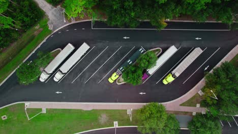 top-down-cinematic-aerial-semi-truck-rest-area-in-Florida-with-highway,-Transportation-concept