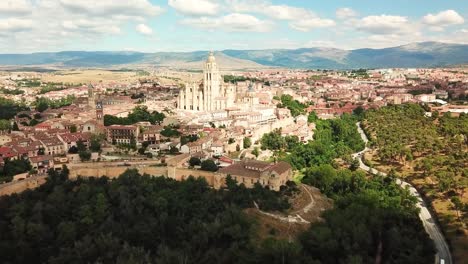 aerial view capturing segovia, spain, with the stunning cathedral and charming cityscape nestled among rolling hills, reflecting the essence of this historic locale, drone establishing shot