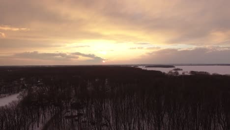 Sunset-over-winter-forest-with-exclusively-deciduous-trees-with-no-leaves