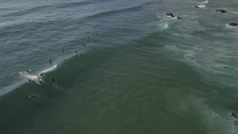 Aerial-drone-view-of-Guincho-beach-with-some-waves-crashing-in-Cascais-Portugal