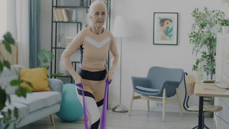 senior woman doing resistance band exercises at home