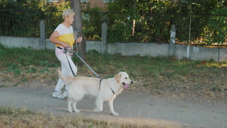 senior woman walking her dog outdoors